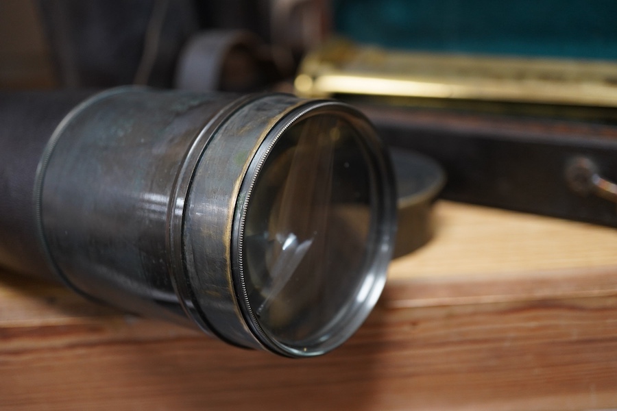 An early 20th century four draw brass telescope with leather grip, together with a brass table top tripod stand, both unmarked, both parts in separate fitted cases, the telescope fully extended 106cm, contracted 28cm